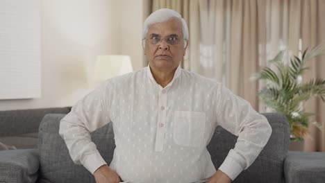 angry indian old man staring at the camera