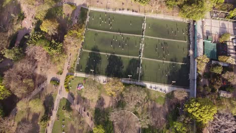 aerial top down flyover football fields with player during training session at las heras park in buenos aires city