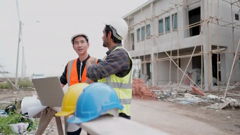 ingeniero civil o arquitecto de construcción explicando sobre el progreso de la construcción de la casa con el propietario del proyecto de vivienda en la computadora portátil en el sitio de construcción. equipo de contratistas profesionales trabajan en el negocio inmobiliario.