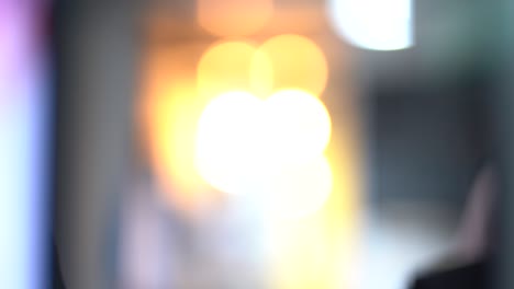 defocused abstract shot people walking across camera and bright lights