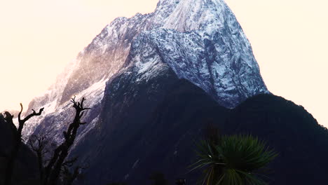 Tilt-up-Shot-Revealing-Snowy-Rugged-Peak-Of-Majestic-Mount-Pembroke-Near-Milford-Sound-In-New-Zealand