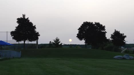 Big-Setting-Sun-Over-Suburban-Park---Grassy-Hill-and-Trees