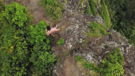 Adventurous-lone-man-hikes-epic-ridge-alongside-cliff-face