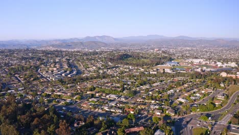 drone flying over san diego freeway towards mountains on the horizon