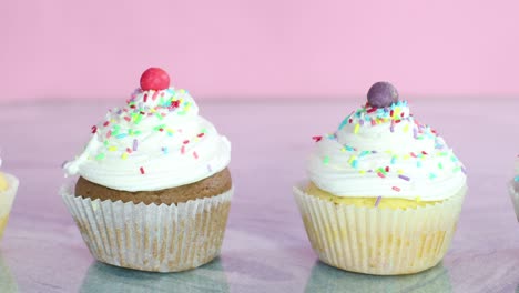 delicious sweet party cupcakes with white cream and crumbs on the table