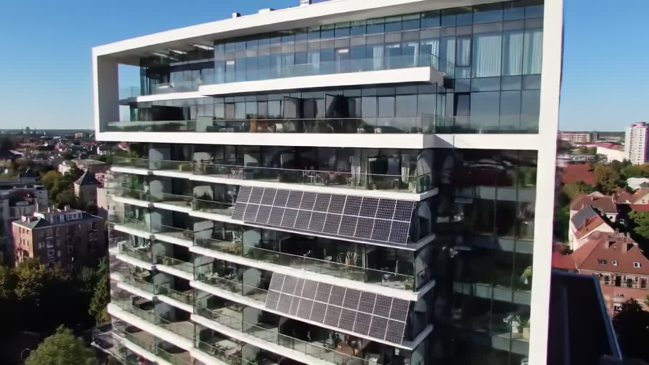 Modern Eco-Friendly Building Showcasing Sustainable Architecture with Solar Panels, Spacious Balconies, and Contemporary Design Aesthetics in a Scenic Urban Setting