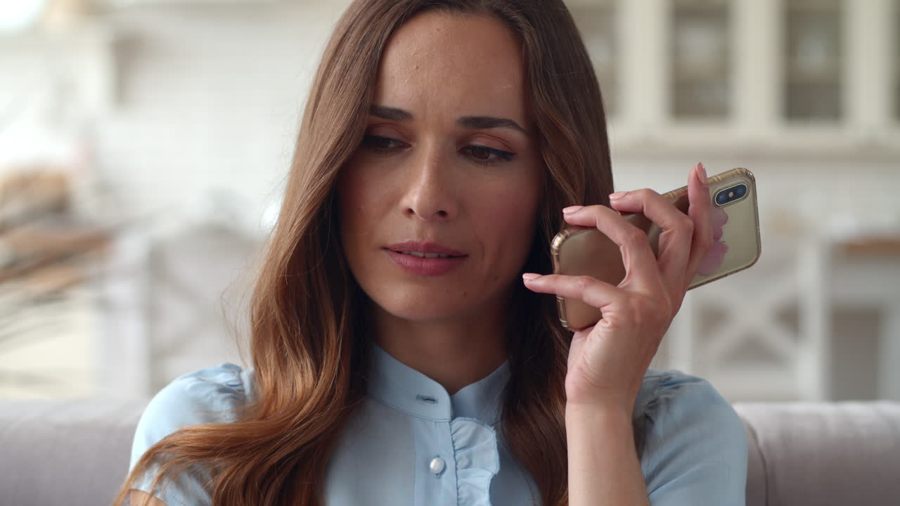 mujer triste haciendo una llamada telefónica en la oficina de casa. chica molesta hablando por teléfono.
