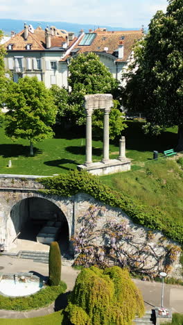 Vertical, aerial: Roman pillars during the day in Nyon, canton of vaud, Switzerland, orbit drone shot