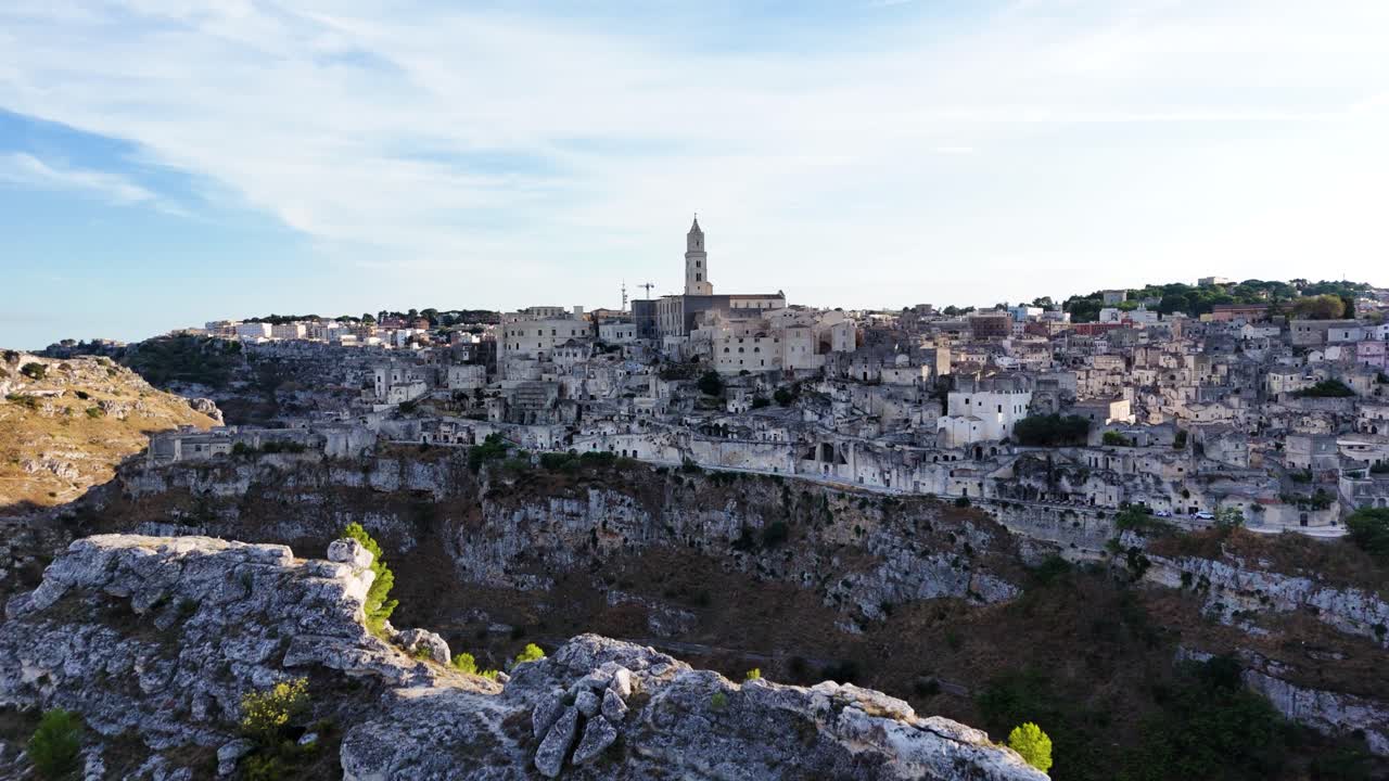 Ancient Matera city and valley, aerial drone fly toward view