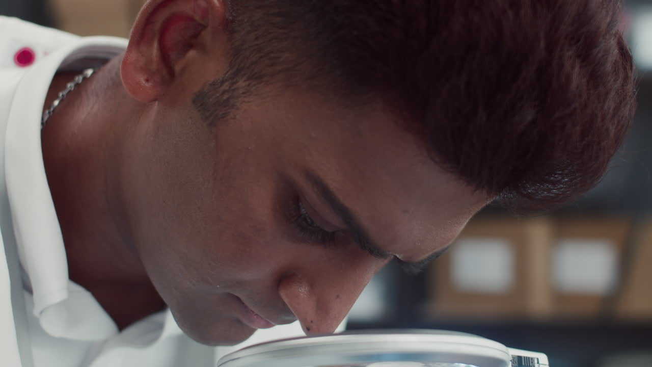 Specialist Using Magnifying Glass during Tablet Repairing