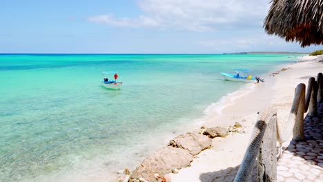 Wide-shot-of-anchored-fisher-boats-on-turquoise-ocean-water-of-Caribbean-Sea-in-Summer