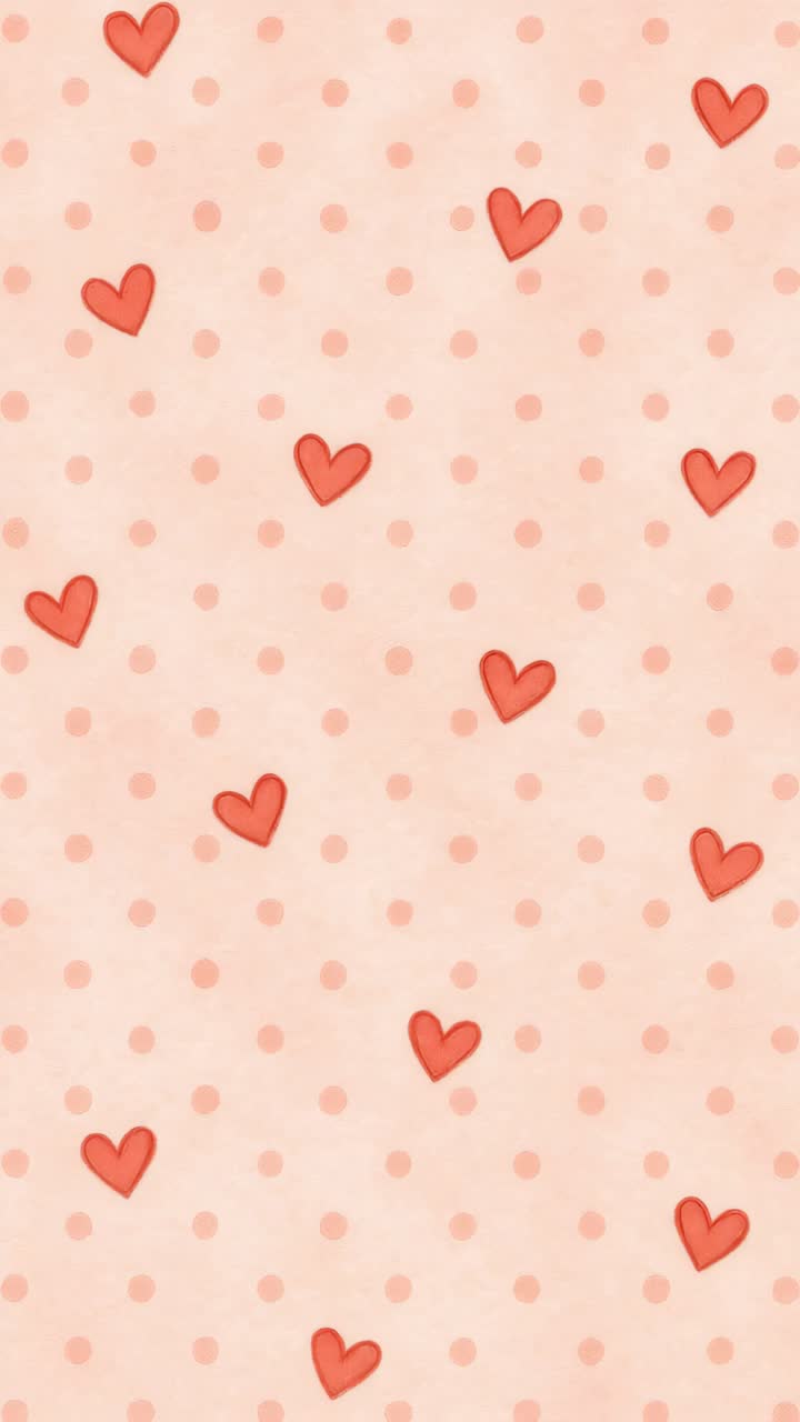 Top-down view of a playful, romantic pattern with red hearts and pink polka dots on a soft