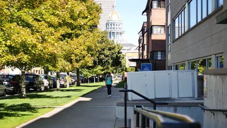 Teenager-walks-down-the-street-in-Capitol-Hill-Denver-talking-on-her-cellphone