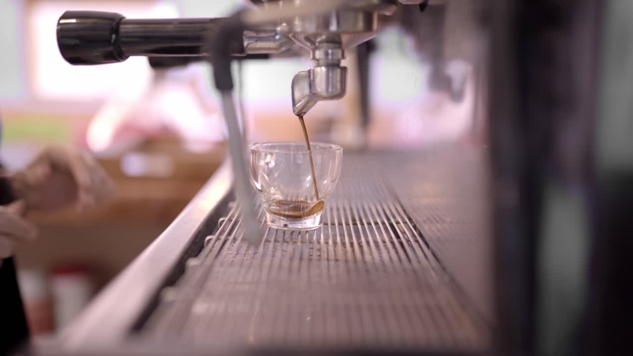 익명의 바리스타가 뜨거운 에스프레소를 만들고 있습니다.