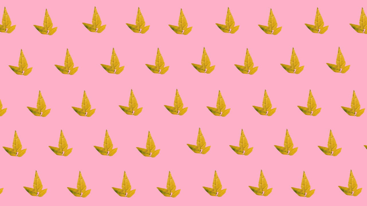 animación digital de varios iconos de hojas de arce de otoño en un patrón sin costuras sobre fondo rosa