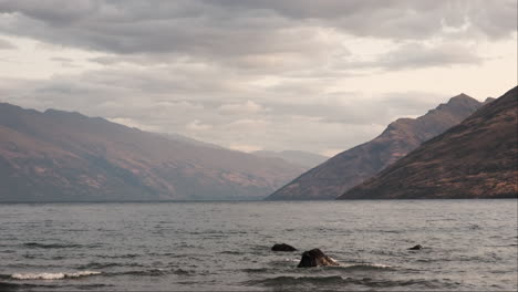 Twilight-over-majestic-mountains-emerging-from-the-calm-waters-of-a-tranquil-lake