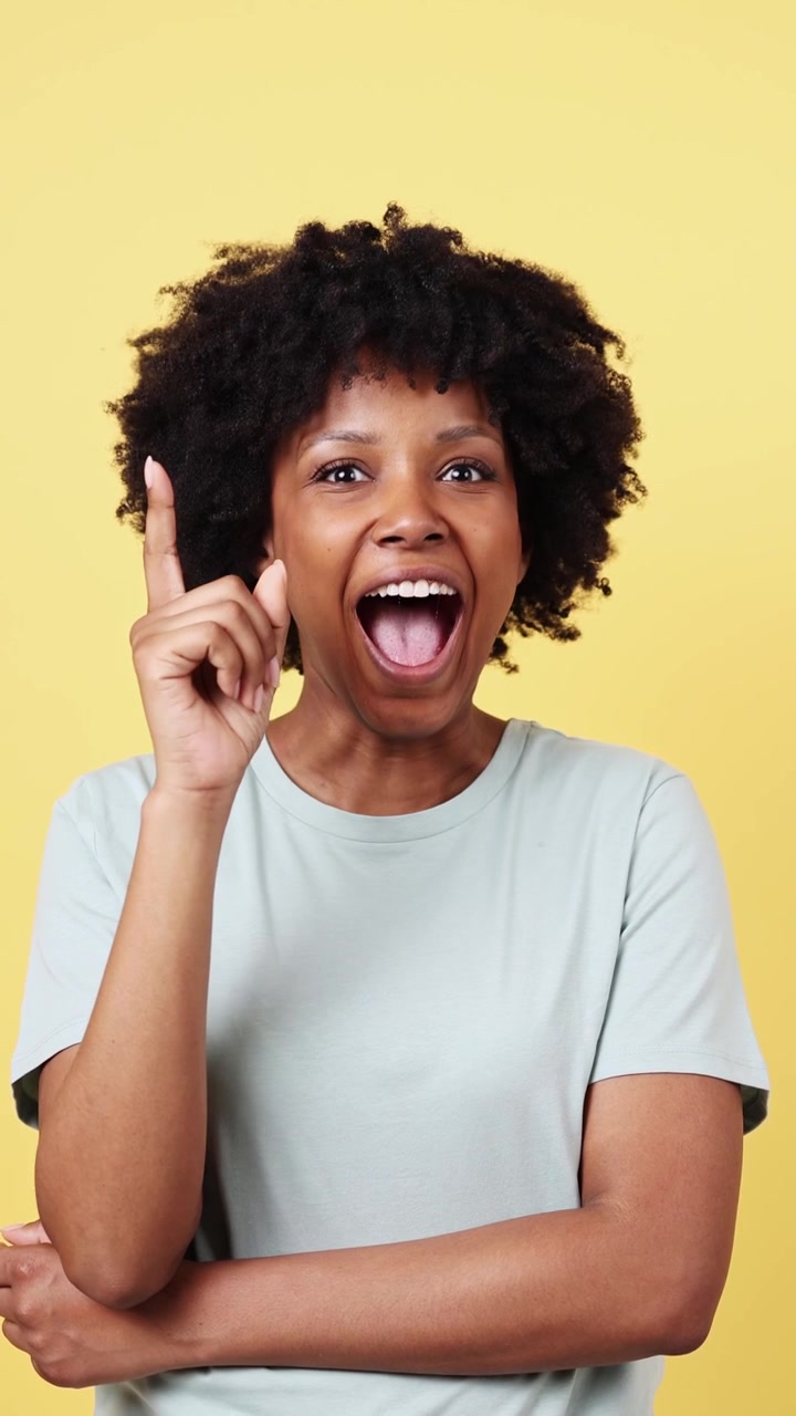 Thoughtful Young Black Woman Gets an Idea and Smiles Happily