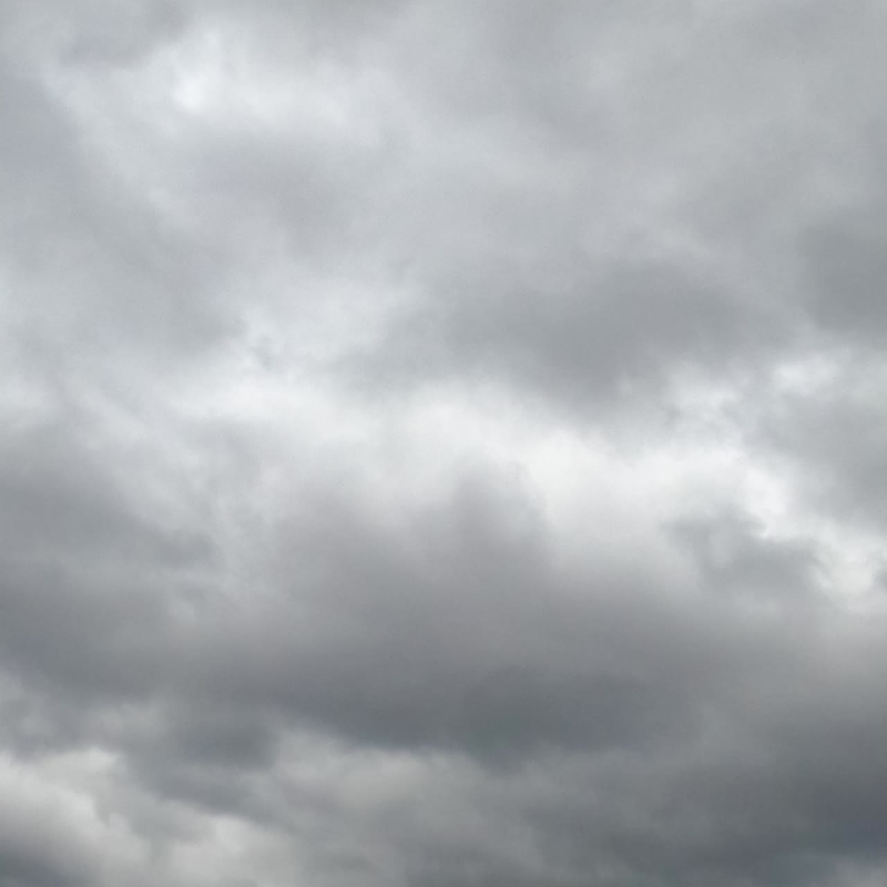 Rainy cloudscape formation in the sky at daytime. Gloomy weather horizon covered with clouds. Low angle view. Timelapse