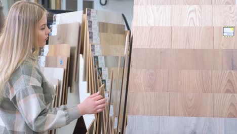 woman choosing flooring samples in a showroom