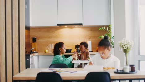 family enjoying a meal and learning in the kitchen