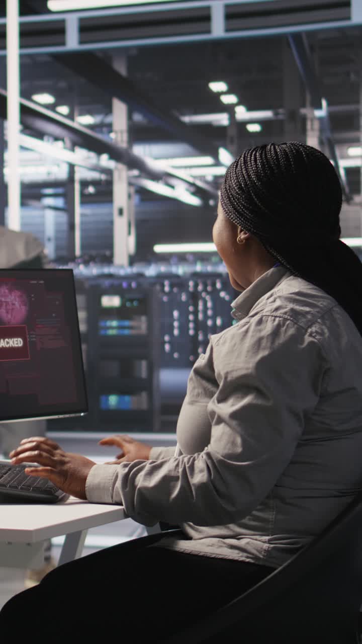 Vertical video Scared data center technicians reacting to virus warning on PC display, running