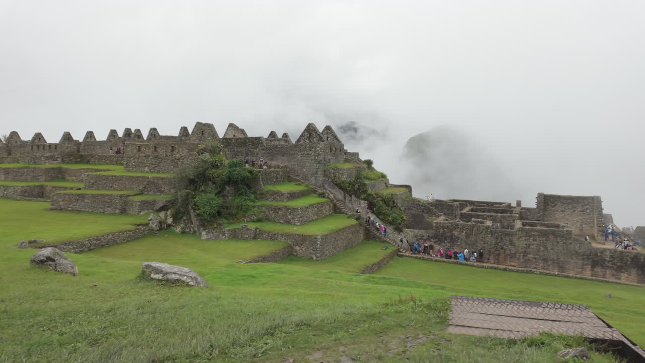 Slow motion video of Inca stone structures inside Machu Picchu, showing ancient walls and architecture in Peru