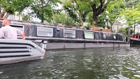 a boat passes through scenic camden canal