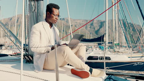 boat, laptop and happy black man typing at sea to