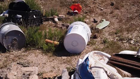 pan across illegal trash dumping from a broken shovelhead to a plastic milk case. scottsdale, arizona
