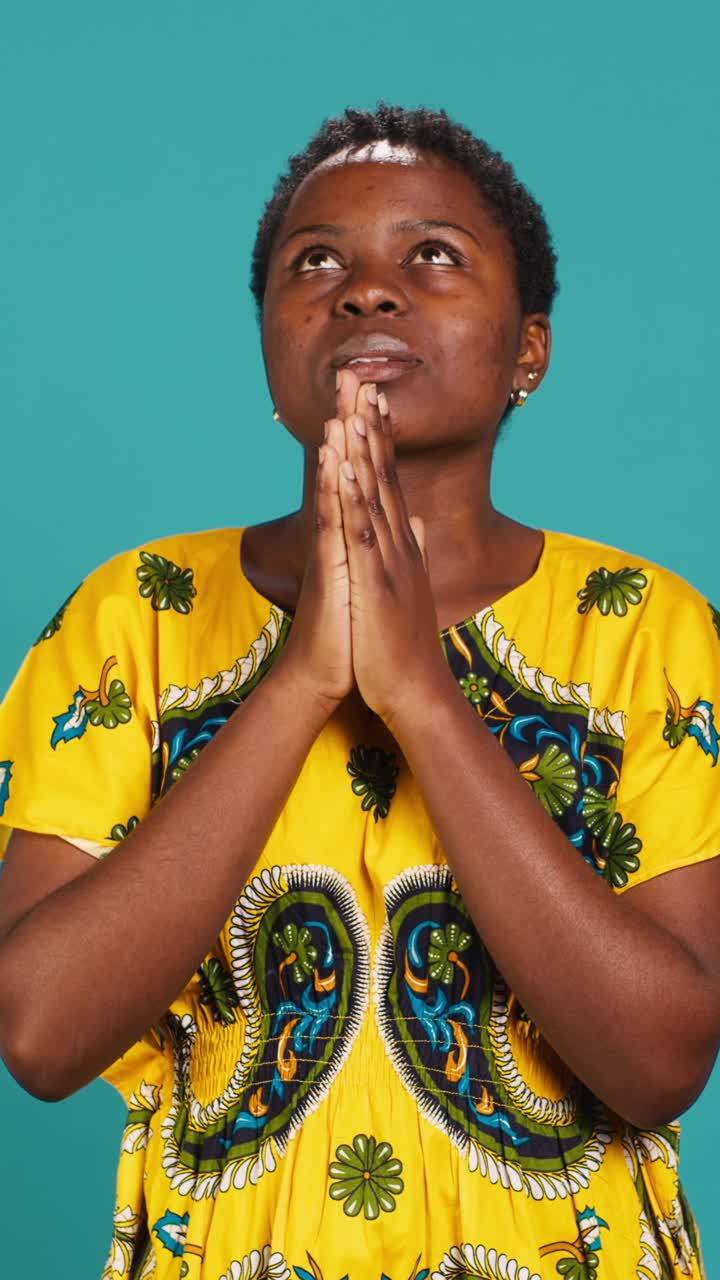 African Woman Praying with Hands Clasped Looking Up