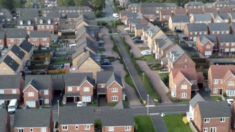 property ladder new british housing estate aerial view overlooking rooftops tilt down left shot