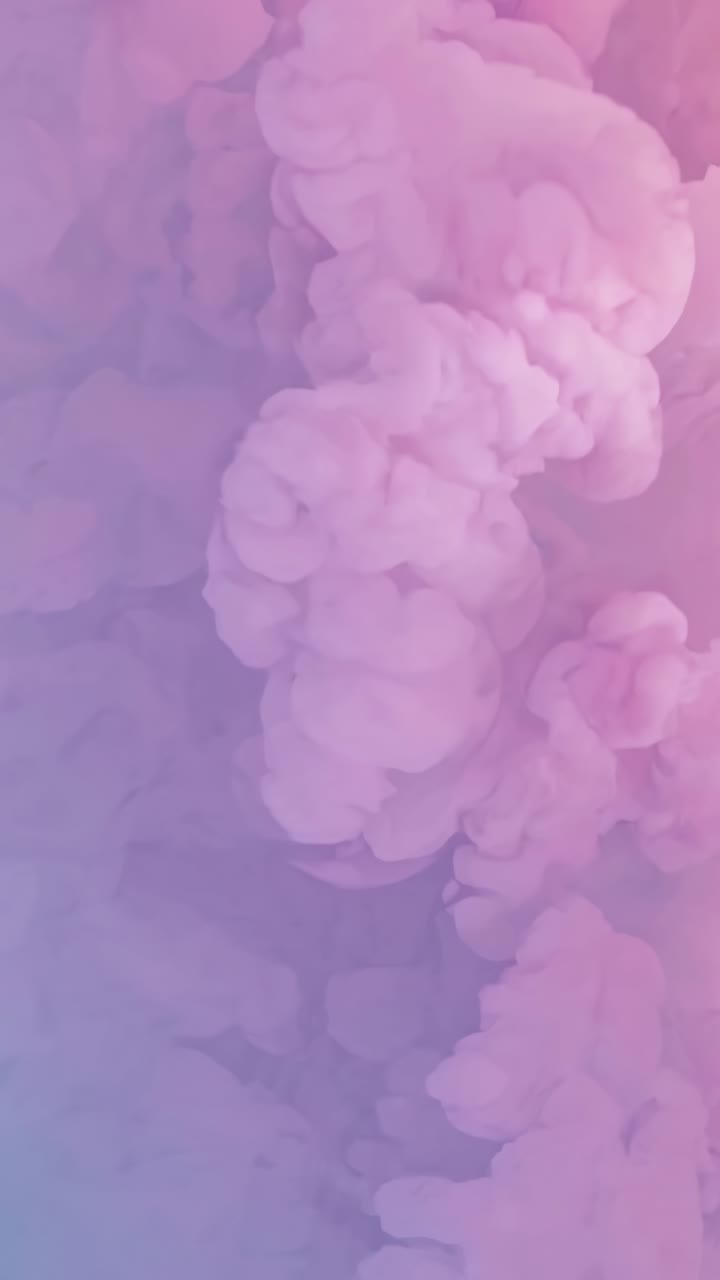 Abstract video of pink and purple smoke swirling upwards, captured from a low-angle view