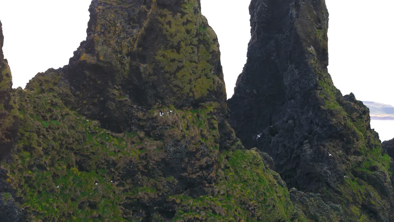 Vista aerea ravvicinata di Reynisdrangar, faraglioni basaltici situati vicino al villaggio di Vík in Islanda.