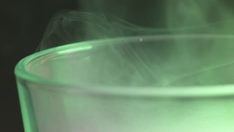 Macro-of-green-fog-hovering-over-a-glass