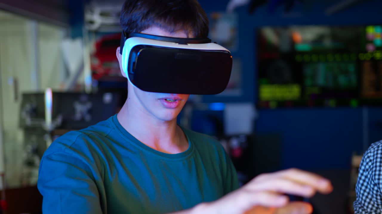 Young engineers with VR virtual reality headset controlling virtual worlds in research laboratory