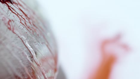 red liquid running down a frozen flower