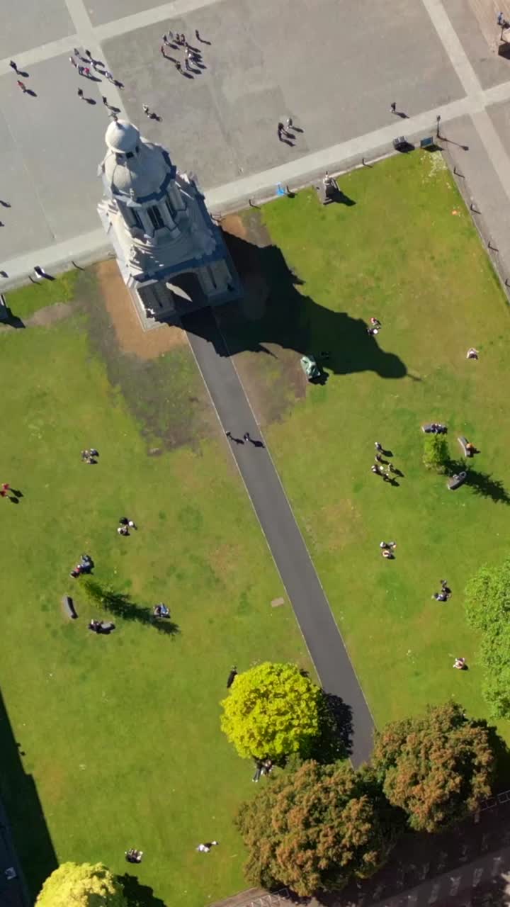 Descending social ratio aerial video of the grounds of Trinity College Dublin in Dublin City Centre, Ireland on a bright and sunny day. Filmed in 1080x1920 and with Rec709 color