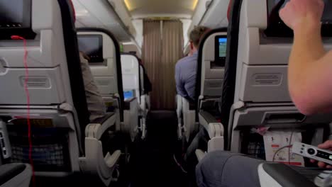 4k-airplane-passenger-cabin-gimbal-shot-airport-departures-terminal-airport-airline-Flight-Passengers