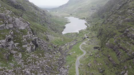 view of a lake by the long country road in the gap of dunloe, county kerry, ireland