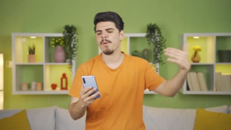 Crazy-and-energetic-young-man-having-fun-dancing-at-home.