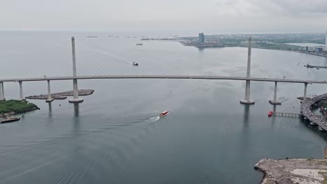 the cebu-cordova link expressway with boat sailing underneath on grey day