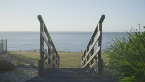 wooden steps leading into beautiful garden on the coast with ocean views