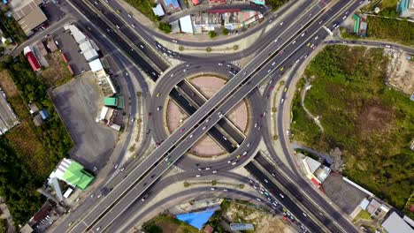 aerial view of highway junctions with roundabout. bridge roads shape circle in structure of architecture and transportation concept. top view. urban city, bangkok at sunset, thailand.