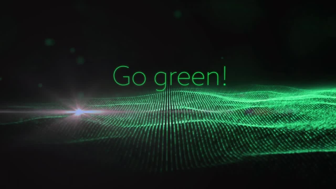 Composition of go green over glitter on black background