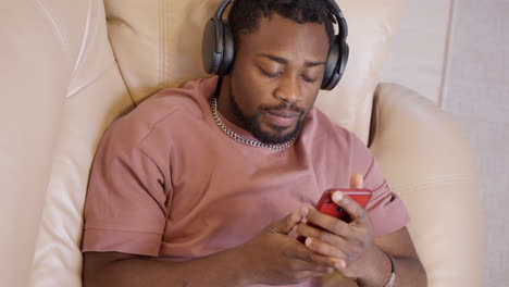 man listening to music and using phone