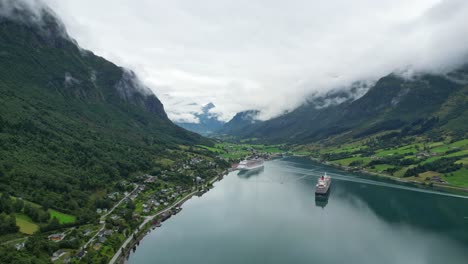 Cruise-Ships-anchored-at-Olden-Village-in-Nordfjord,-Vestland,-Norway,-Scandinavia---Aerial