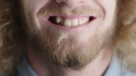 cerrar la boca de un joven sonriente feliz hombre caucásico con barba mitad de la cara concepto de emoción