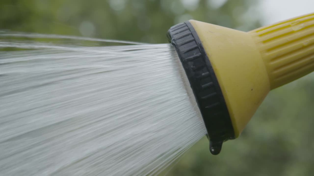 Close up of water coming out of garden hose