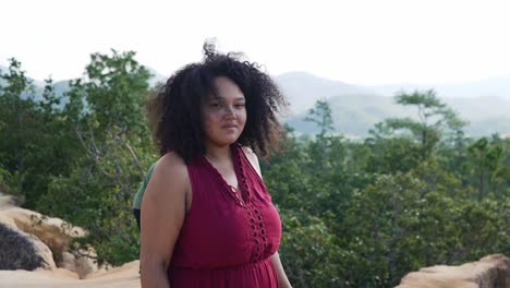 Black-curly-woman-scared-of-hights-focussing-and-smiling-at-the-camera