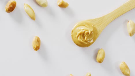 Video-of-close-up-of-peanut-butter-on-white-background